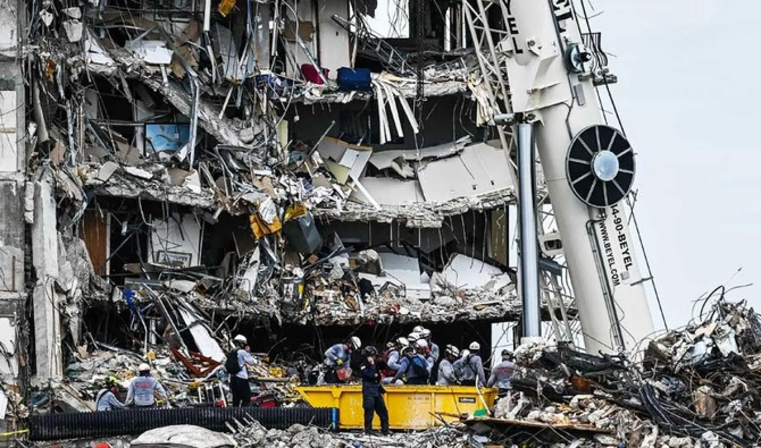 File Photo - Search and Rescue teams look for possible survivors in the partially collapsed 12-story Champlain Towers South condo building on June 29, 2021 in Surfside, Florida. (AFP)

