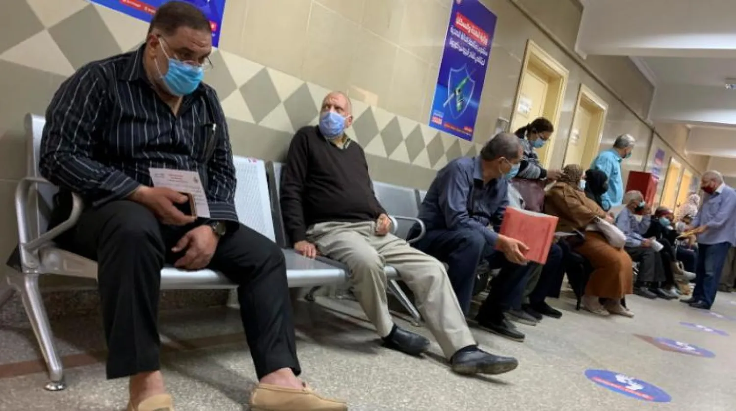  People wearing masks at a vaccination center in Cairo. (Reuters) 
