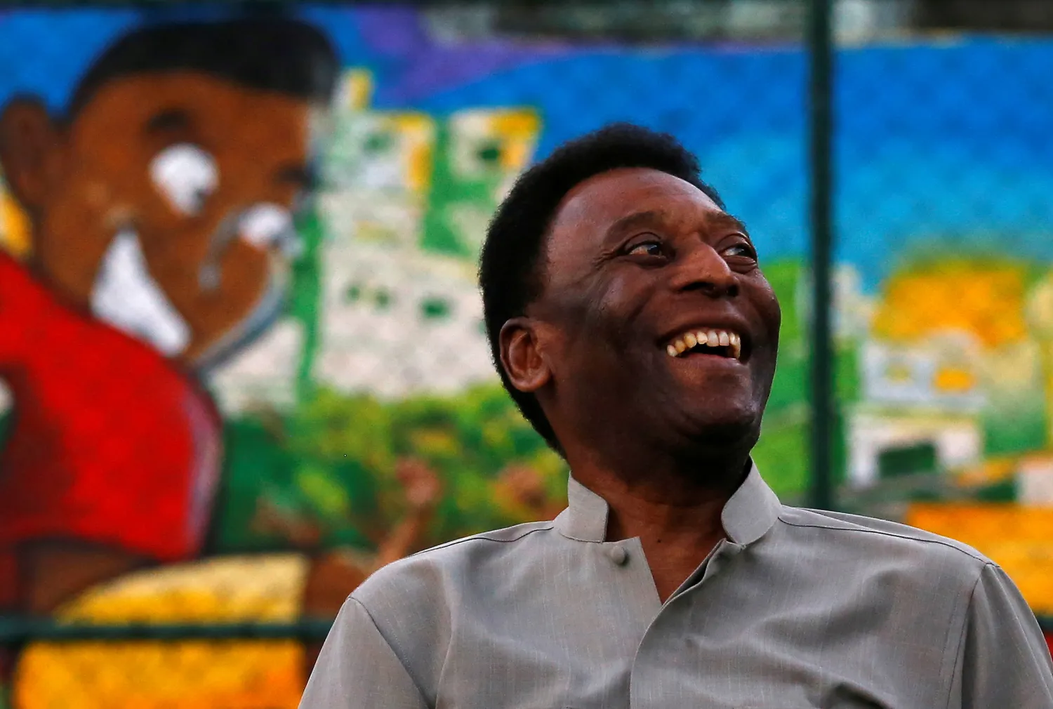 Brazilian soccer legend Pele laughs during the inauguration of a refurbished soccer field at the Mineira slum in Rio de Janeiro September 10, 2014. REUTERS/Ricardo Moraes/File Photo