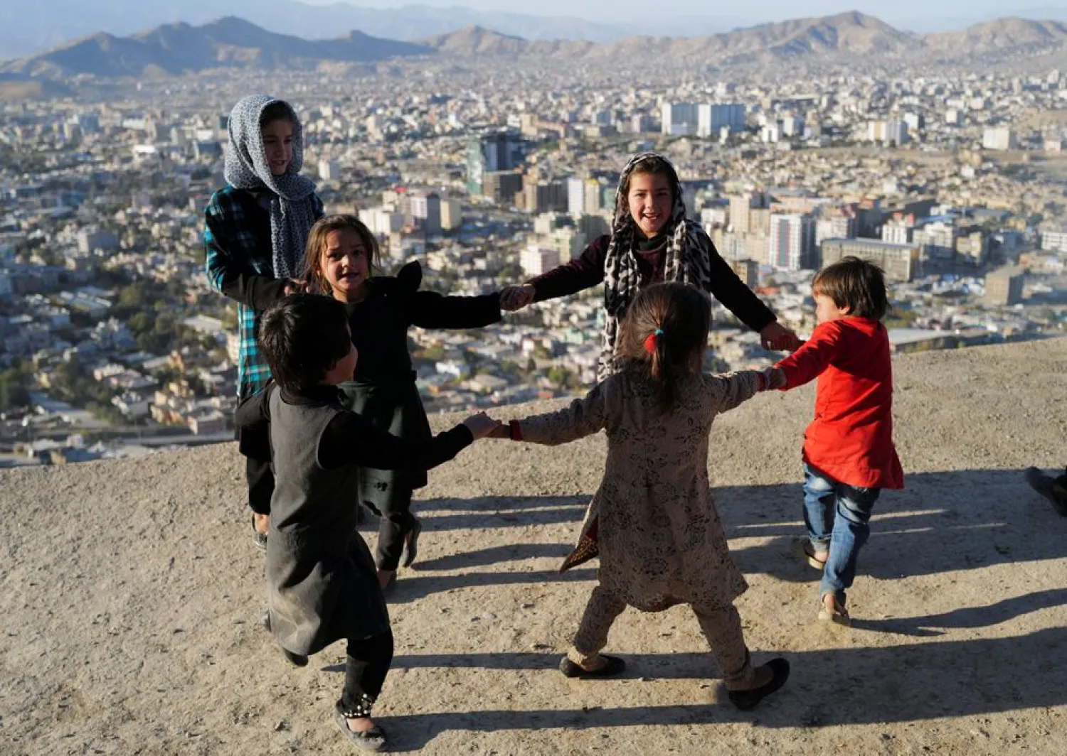 Children play outside their house at Tv mountain in Kabul, Afghanistan October 15, 2021. REUTERS/Zohra Bensemra/Files
