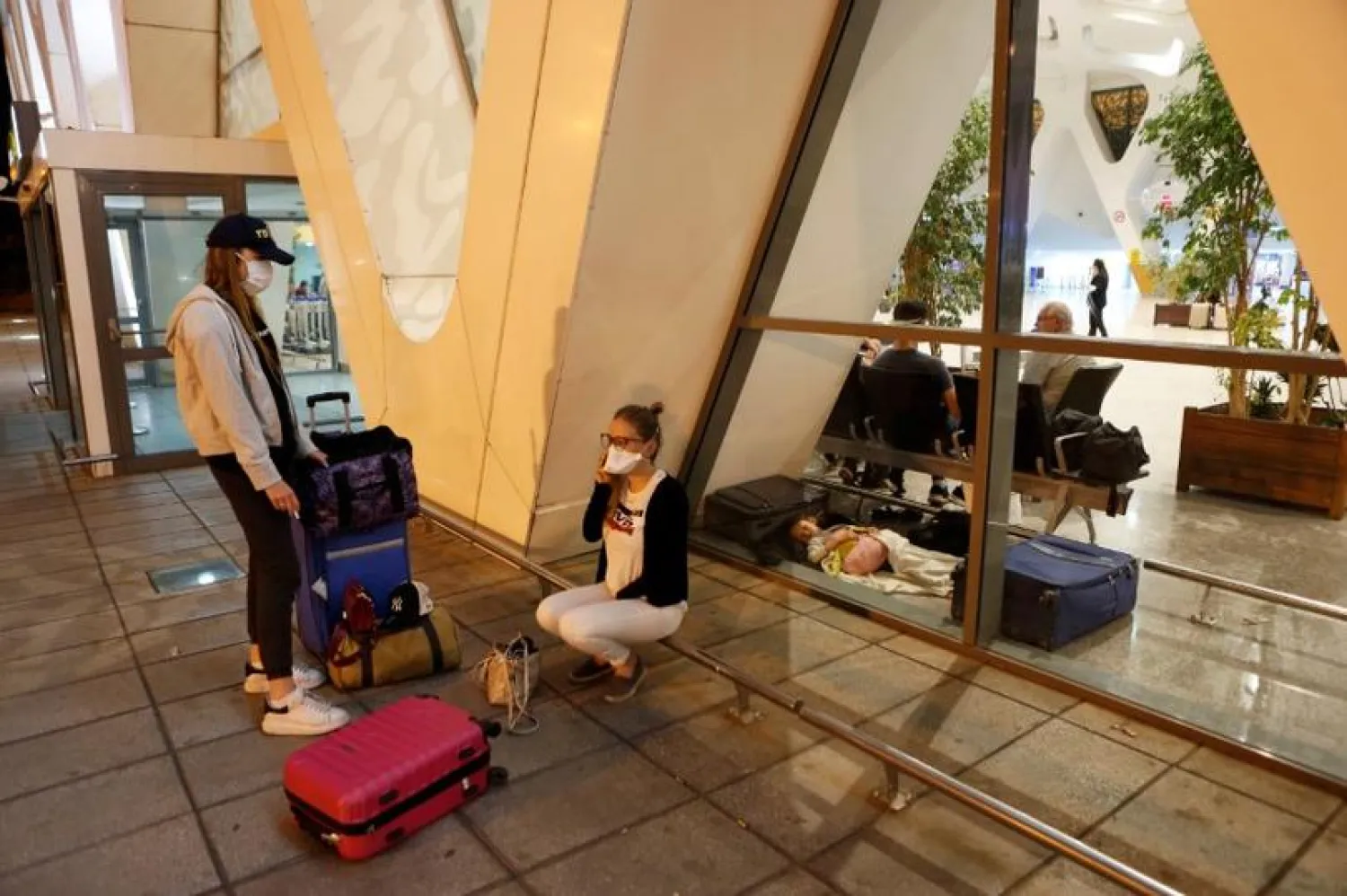 Tourists wait to be repatriated to their countries as Morocco suspends flights to European countries over coronavirus (COVID-19) fears, at Marrakech airport, Morocco, March 14, 2020. (Reuters)