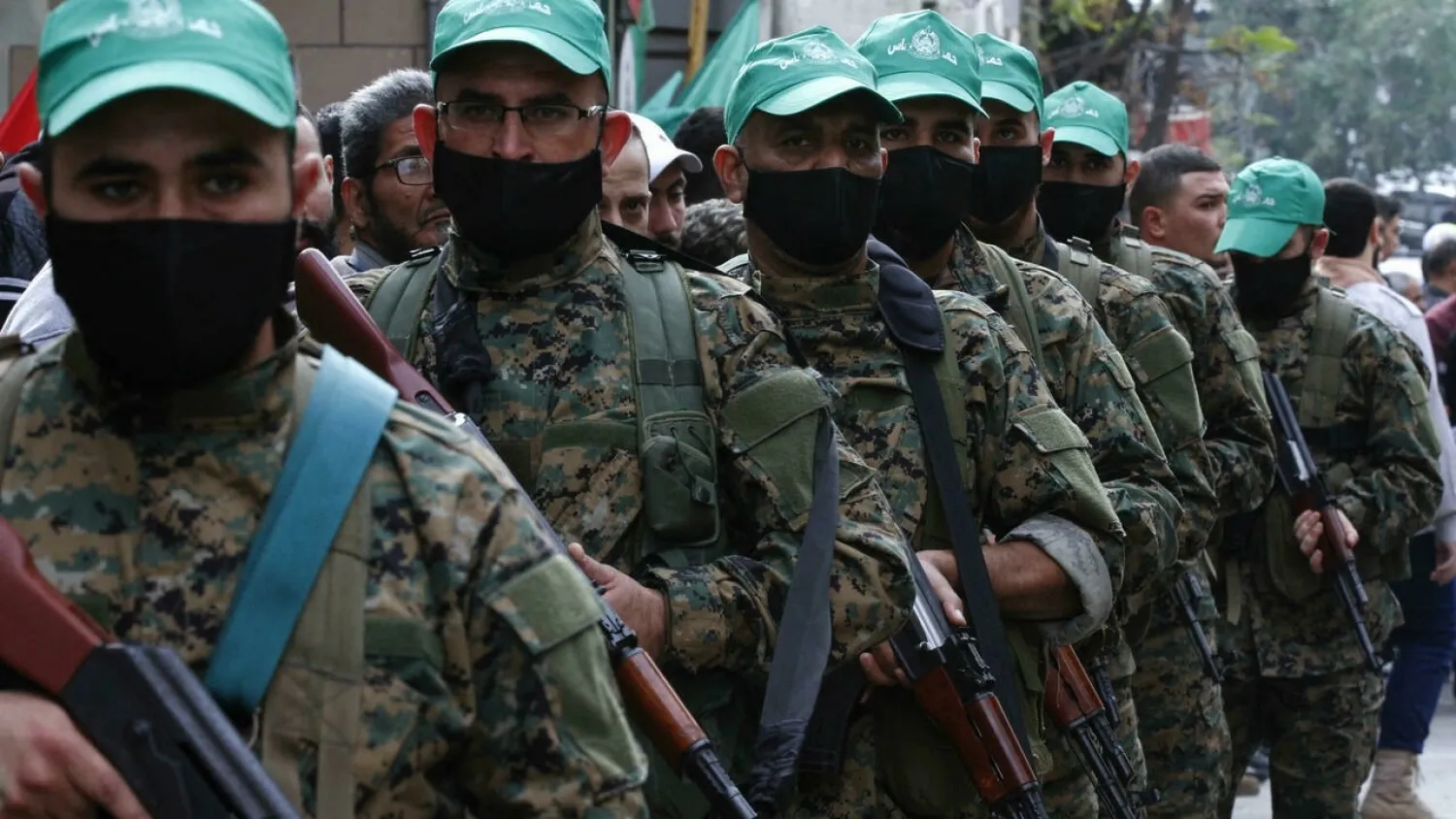 Fighters take part in a funeral procession for Hamza Ibrahim Shahin, a member of the Hamas movement, in the Burj al-Shamali camp for Palestinian refugees. (AFP)