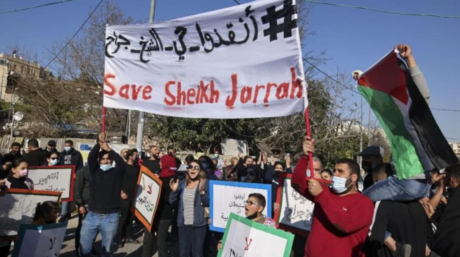 Activists protest Israeli occupation in Sheikh Jarrah, Jerusalem, on 19 March 2021 (AFP)

