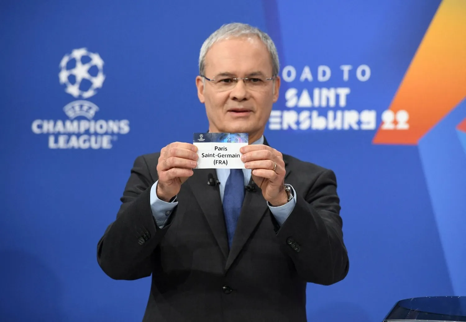 UEFA Deputy General Secretary Giorgio Marchetti draws out the card of Paris St Germain during the UEFA Champions League 2021/22 Round of 16 Draw at the UEFA headquarters, Nyon, Switzerland, Dec. 13, 2021. (Reuters)