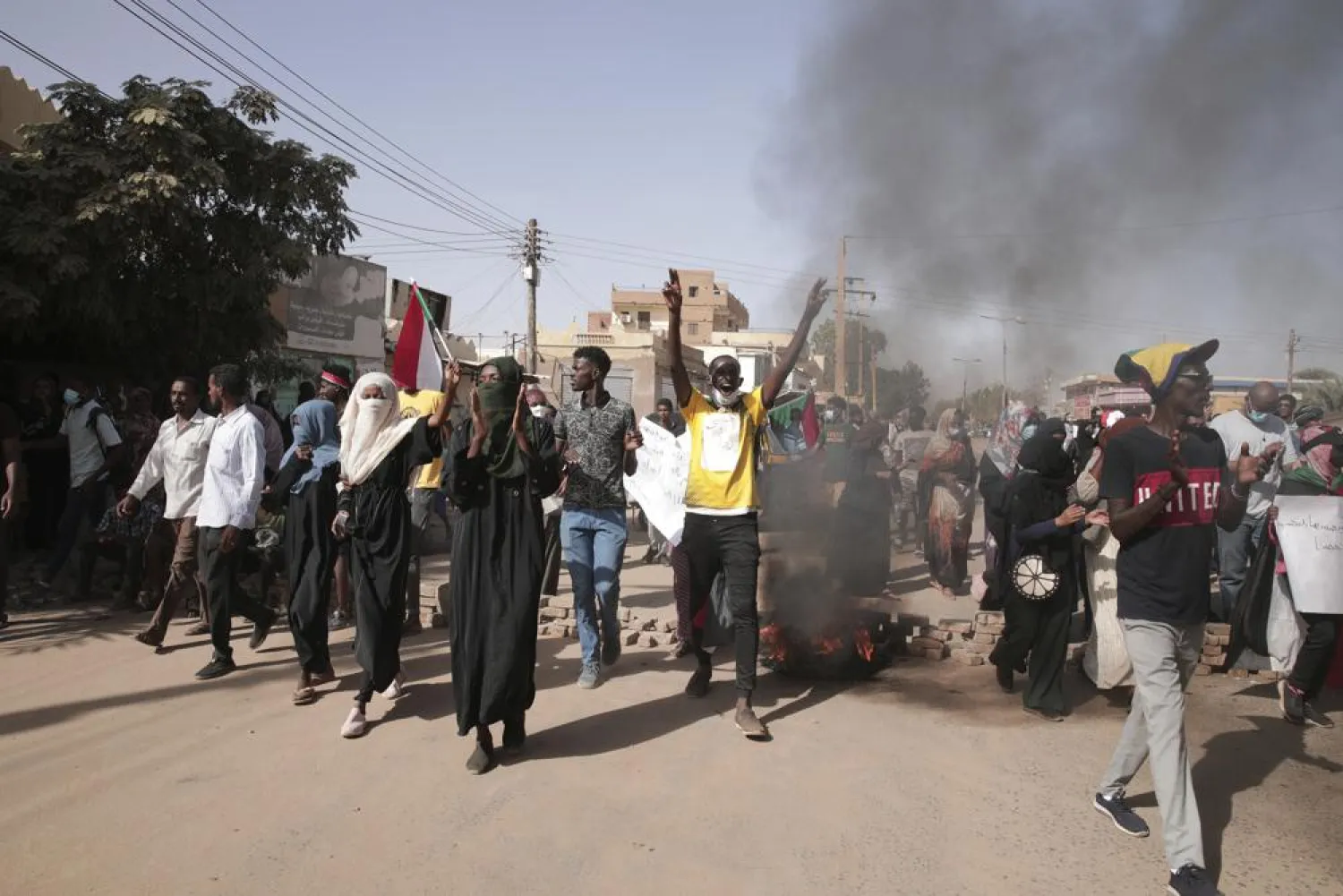 People protests against the October military coup and subsequent deal that reinstated Prime Minister Abdalla Hamdok in Khartoum, Sudan, Monday, Dec. 13, 2021. (AP)