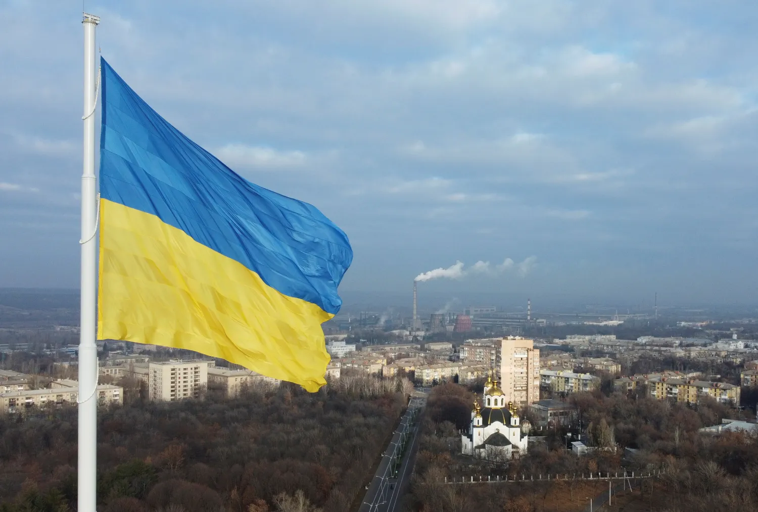 The national flag of Ukraine flies over the town of Kramatorsk, Ukraine November 25, 2021. Picture taken with a drone on November 25, 2021. REUTERS/Valentyn Ogirenko