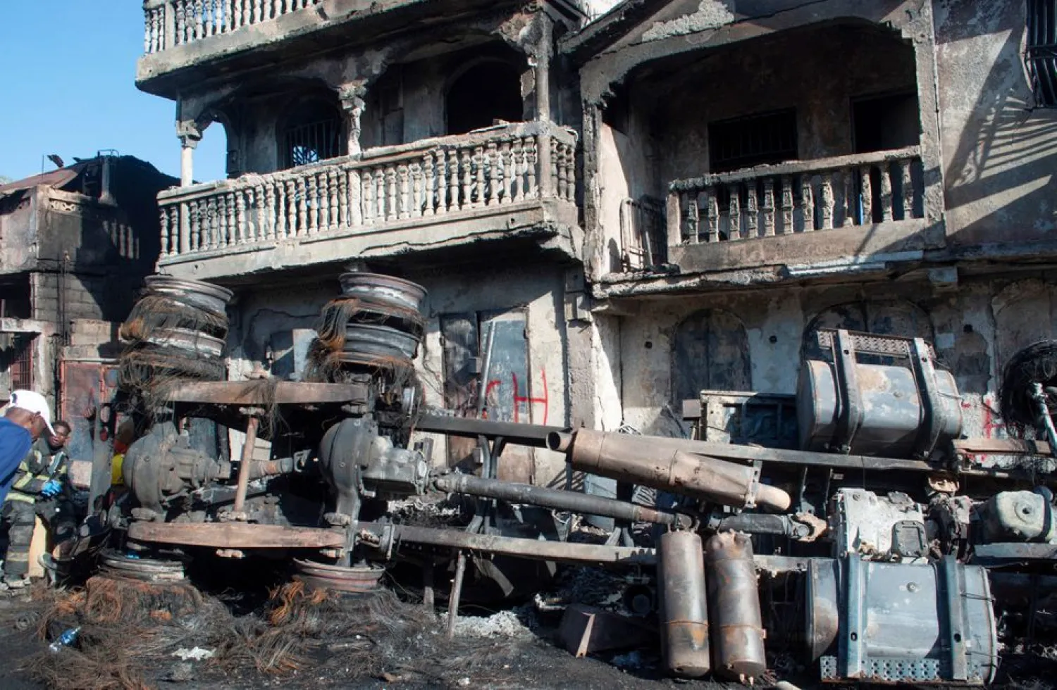 A burnt fuel truck lies overturned next to a destroyed house after the truck exploded in a neighbourhood during the night, in Cap Haitien, Haiti December 14, 2021. (Reuters)