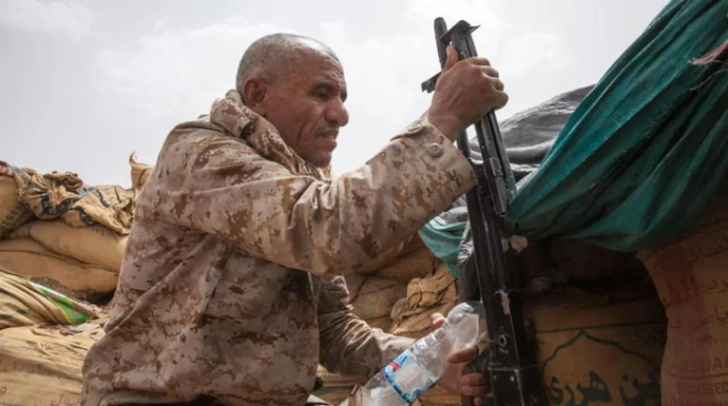  An officer in the Yemeni army carries his weapon on the frontlines, in the fight against the Iranian-backed Houthi militias near Marib. (AP) 
