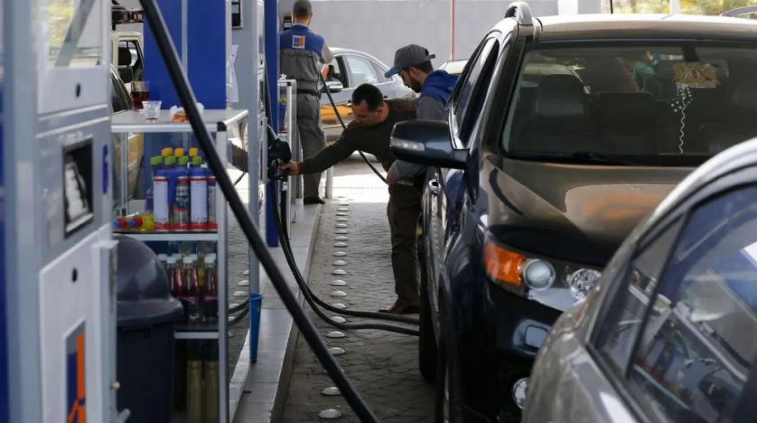 File Photo: Syrians queue to fill their car with gasoline at a station in Damascus. Louai Beshara/AFP