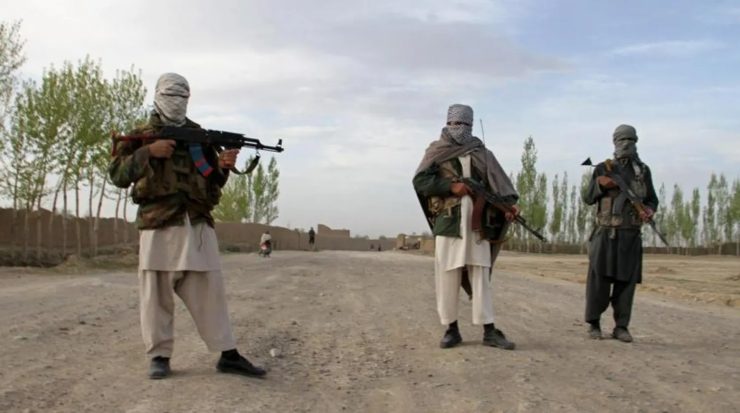Members of the Taliban stand at the site of the execution of three men in Ghazni province, Afghanistan, April 18, 2015. REUTERS/Stringer/File Photo
