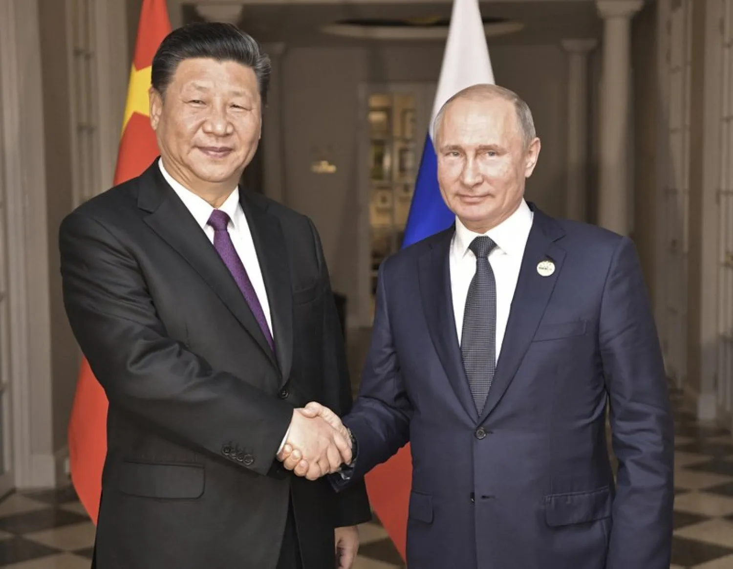 FILE - In this July 26, 2018, file photo, China's President Xi Jinping, left, poses with Russia's President Vladimir Putin for a photo at the BRICS summit in Johannesburg, South Africa. (Alexei Nikolsky, Sputnik, Kremlin Pool Photo via AP, File)