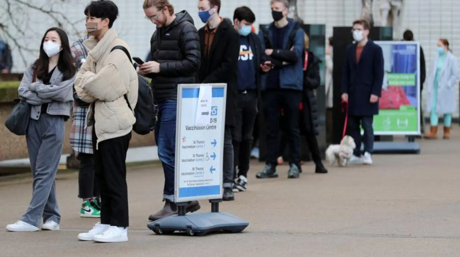 People queue outside a coronavirus disease (COVID-19) vaccination center at St Thomas' Hospital as the pandemic continues, in London, Britain, December 12, 2021. (Reuters)