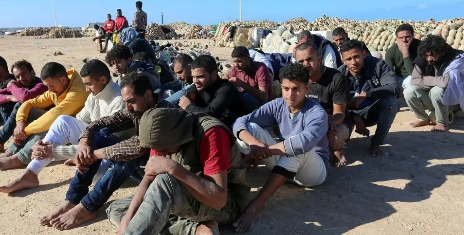 Migrants rescued by Tunisia’s national guard during an attempted crossing of the Mediterranean by boat, rest on the beach at the port of el-Ketef in Ben Guerdane in southern Tunisia near the border with Libya, on December 15, 2021. (AFP/Fathi Nasri)
