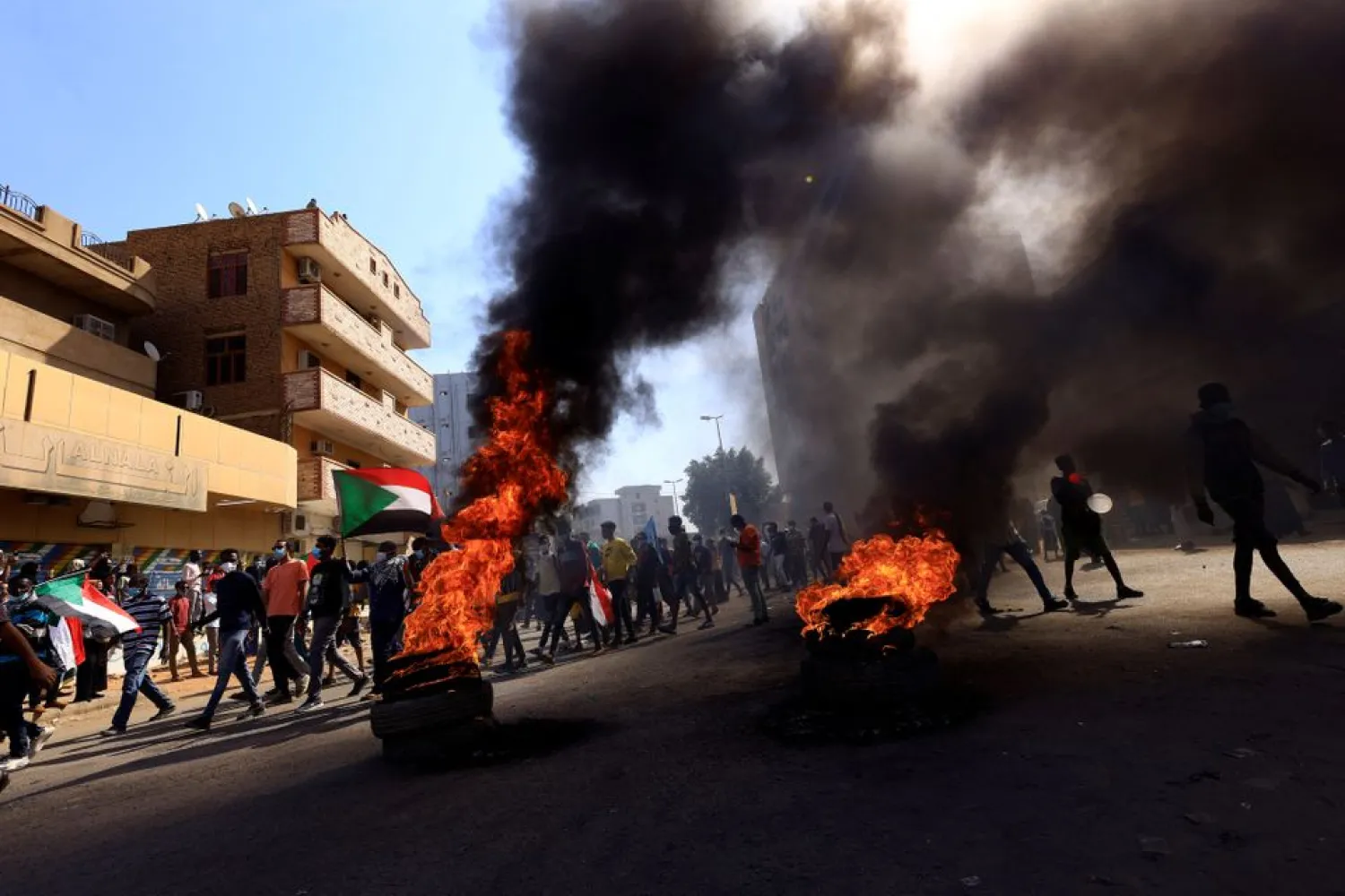 People march to the presidential palace, protesting against military rule following last month's coup in Khartoum, Sudan December 19, 2021. (Reuters)
