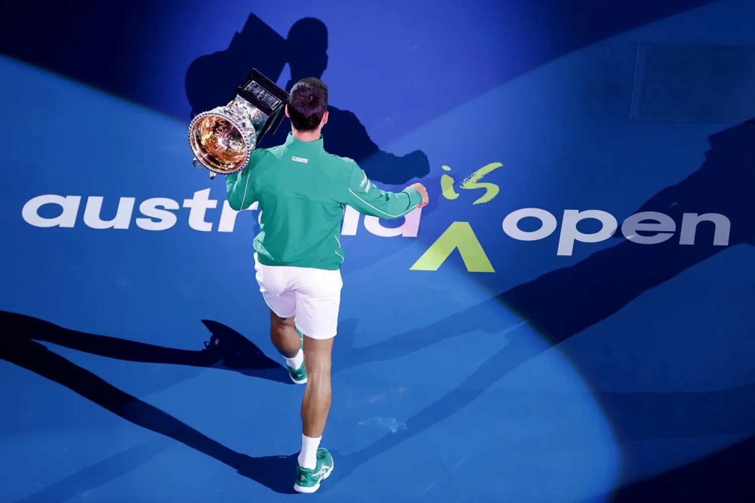 Novak Djokovic holds his trophy after winning the Australian Open tennis tournament, in Melbourne, Australia, Feb. 3, 2020. (AP)