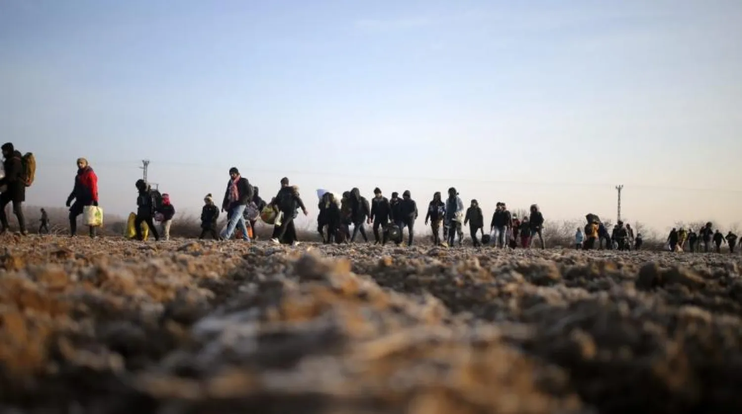Migrants walk to reach Pazarakule border gate, Edirne, Turkey, at the Turkish-Greek border on Sunday. (AP)
