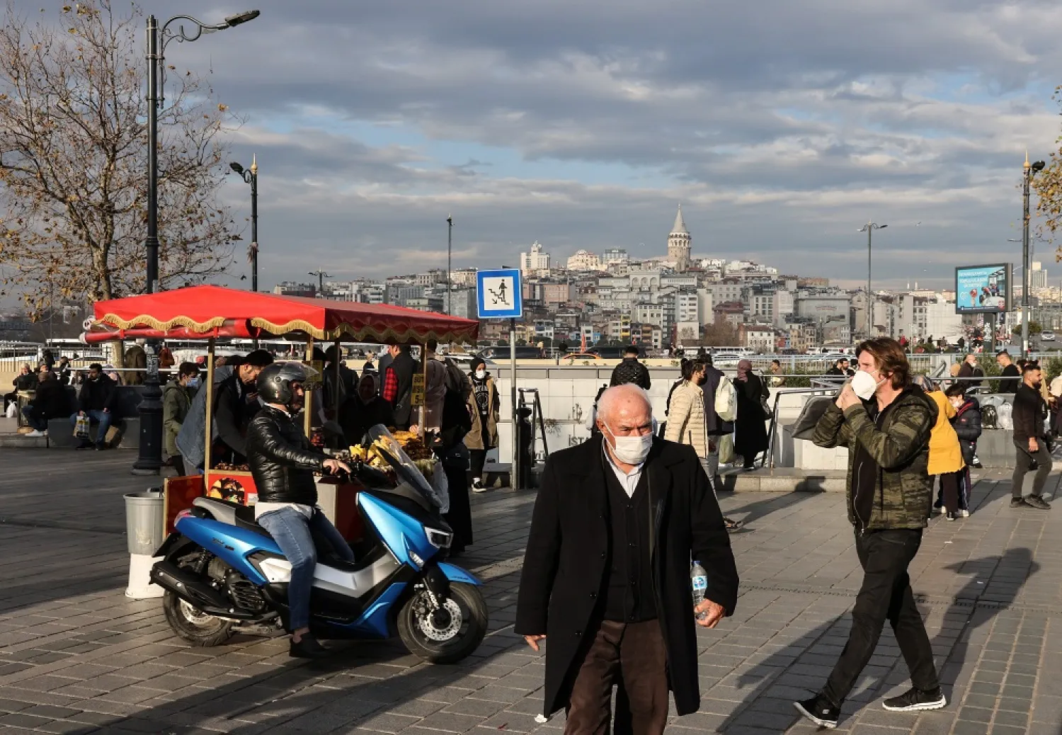 People wearing protective masks against COVID-19 walk in Eminönü, in Istanbul, Turkey, Dec. 6, 2021. (Reuters)