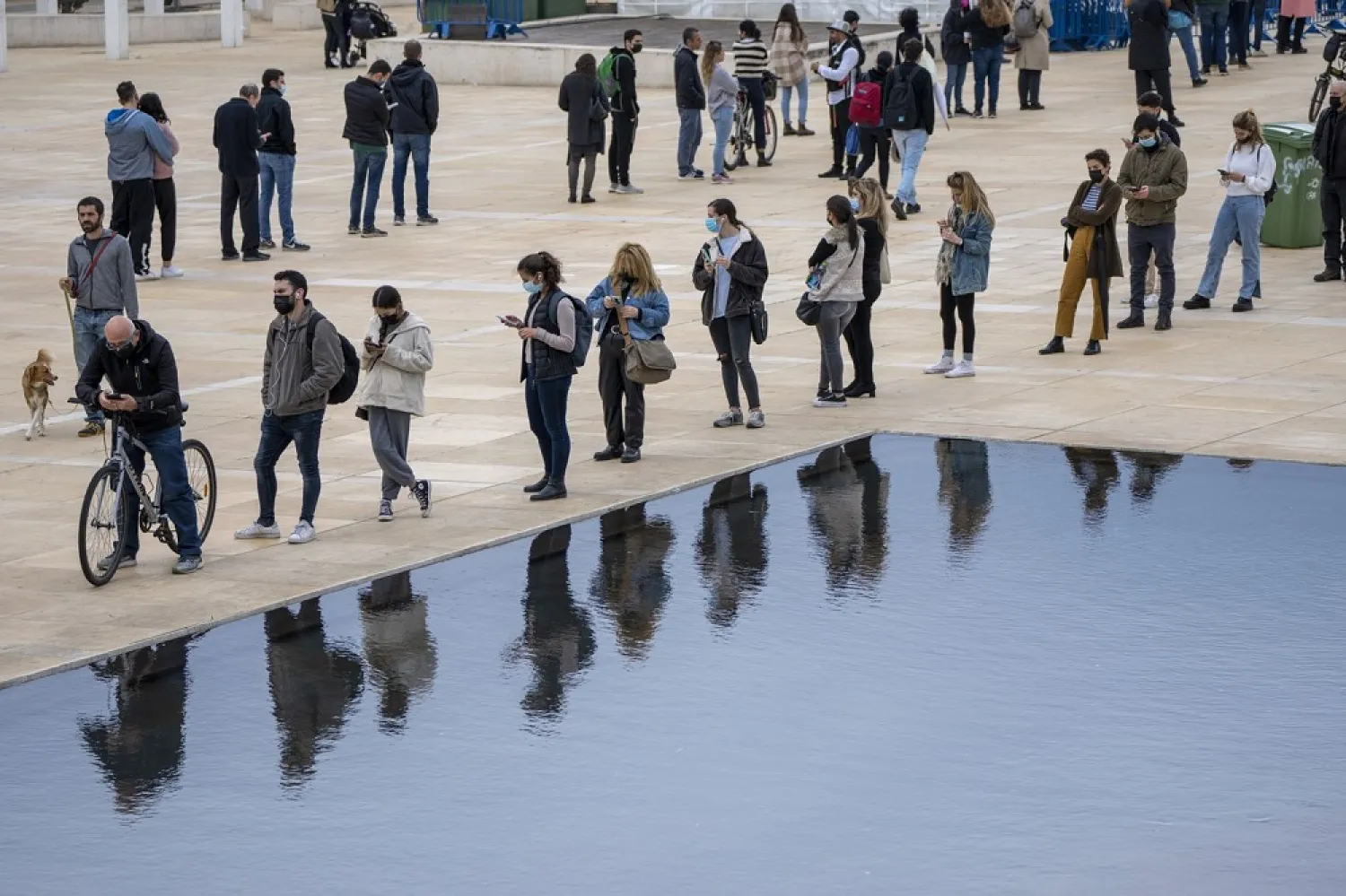 People, some wearing protective face masks, line up for PCR and Rapid Antigen COVID-19 coronavirus tests in Tel Aviv, Israel, Tuesday, Jan. 4, 2022. (AP)
