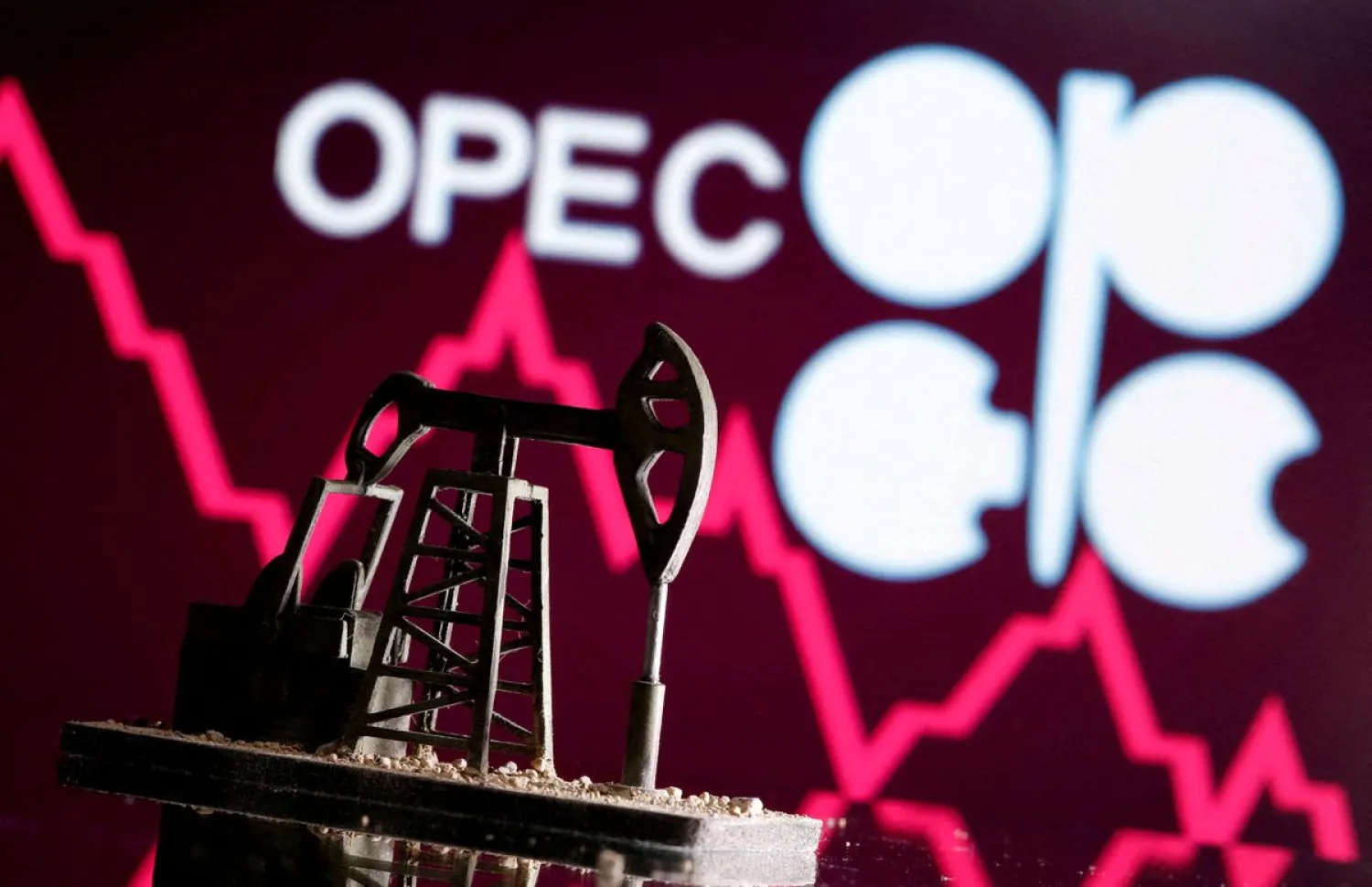 A 3D printed oil pump jack is seen in front of displayed stock graph and OPEC logo in this illustration picture, April 14, 2020. REUTERS/Dado Ruvic