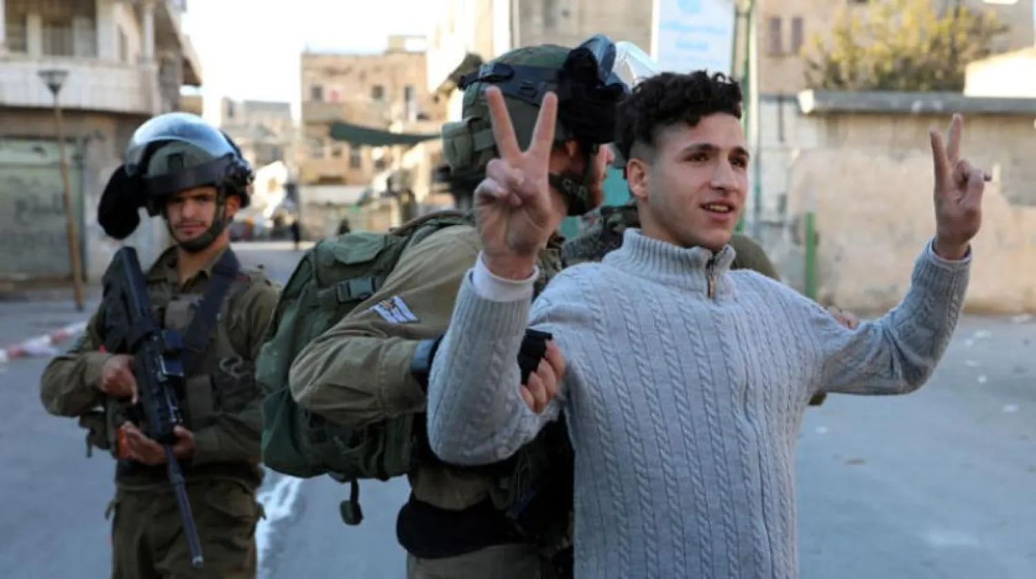 Israeli soldiers arrest a Palestinian man in Hebron on Friday. (EPA) 