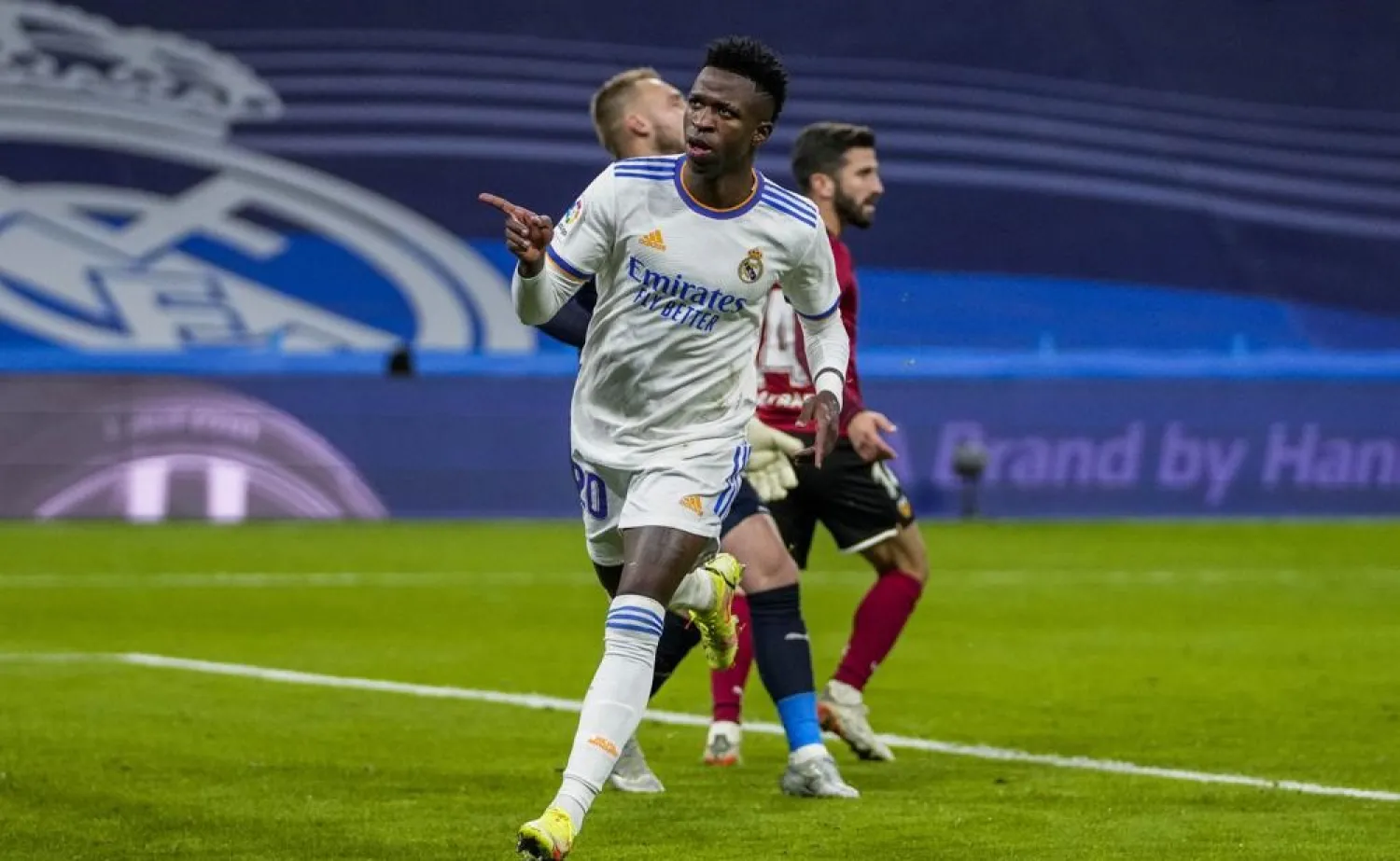 Real Madrid's Vinicius Junior celebrates after scoring his team second goal during the La Liga match between Real Madrid and Valencia at Santiago Bernabeu stadium in Madrid, Spain, Saturday, Jan. 8, 2022. (AP)