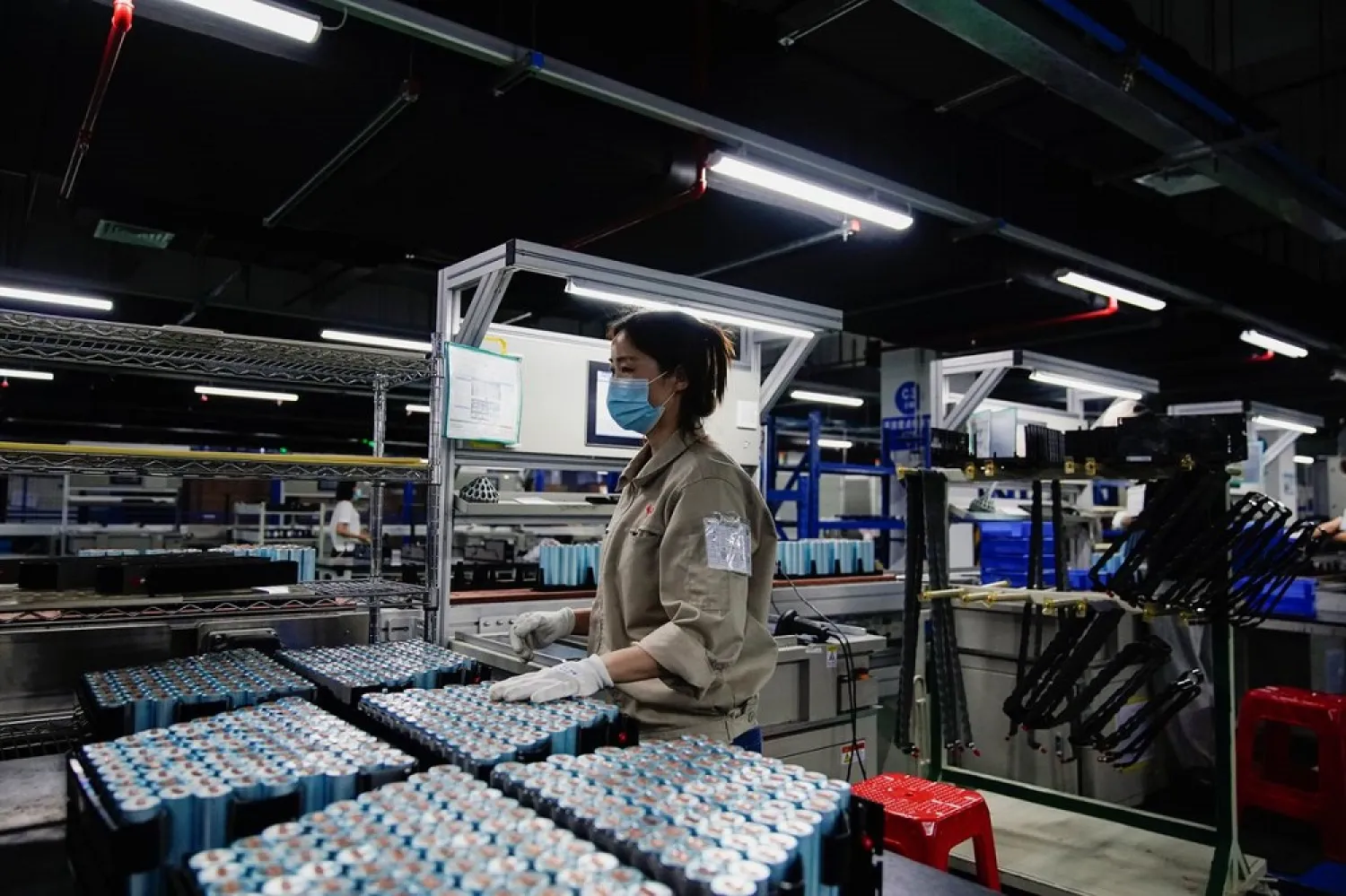 An employee works on the production line of electric vehicle (EV) battery manufacturer Octillion in Hefei, Anhui province, China March 30, 2021. Picture taken March 30, 2021. (Reuters)