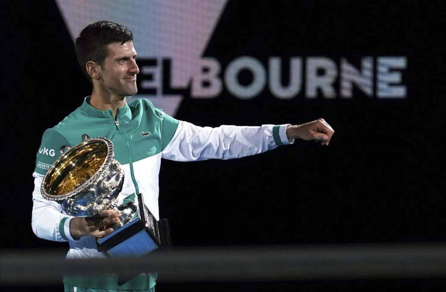 Serbia's Novak Djokovic holds the Norman Brookes Challenge Cup after defeating Russia's Daniil Medvedev in the men's singles final at the Australian Open tennis championship in Melbourne, Australia, Sunday, Feb. 21, 2021. (AP)