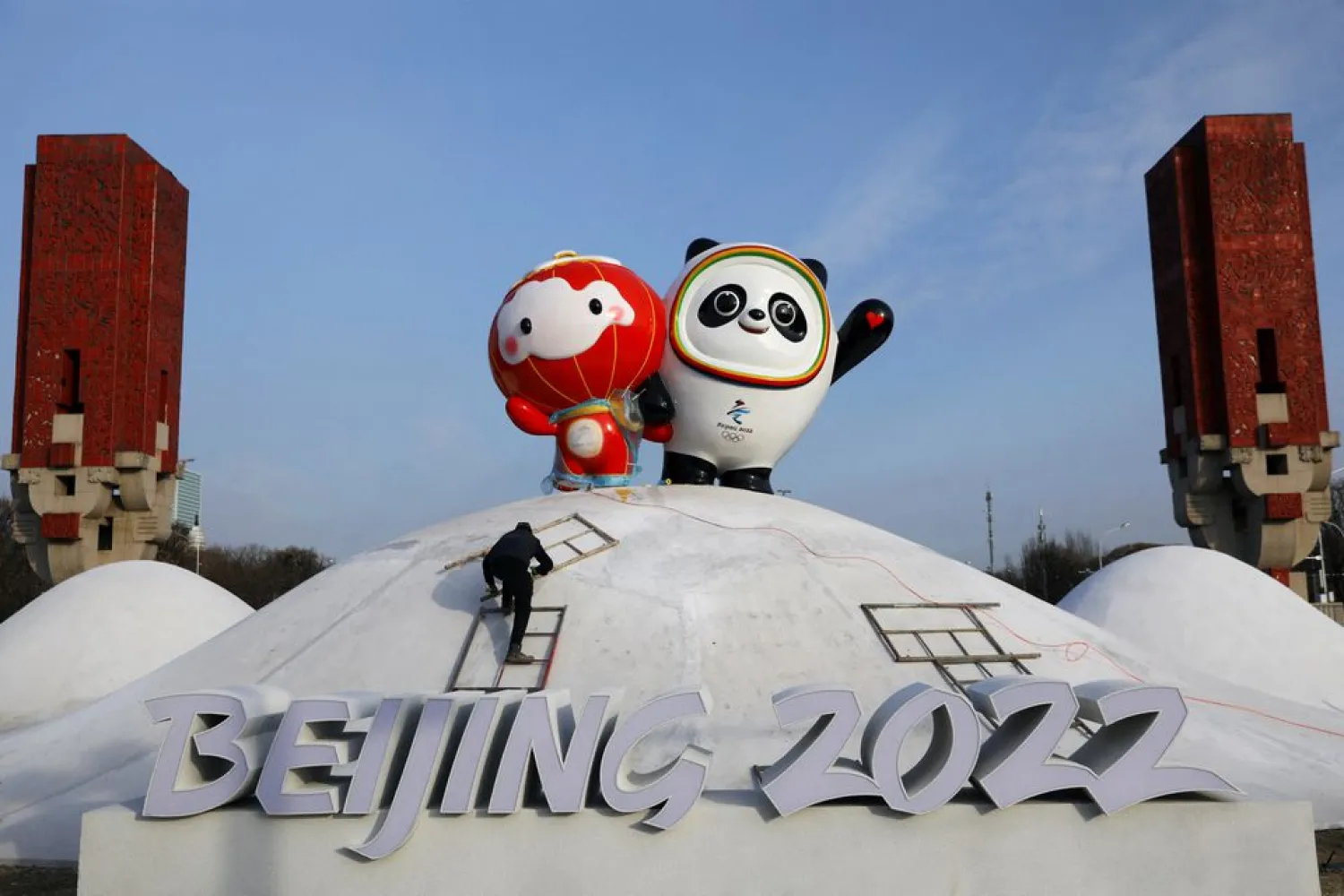 A worker sets up an installation featuring Bing Dwen Dwen, the Beijing 2022 Winter Olympic Mascot and Shuey Rhon Rhon, the 2022 Beijing Winter Paralympic Games Mascot, in Beijing, China January 11, 2022. (Reuters)