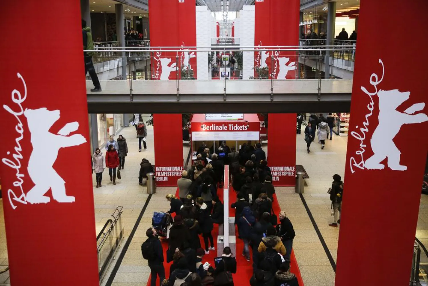 FILE - People line up in front of a ticket counter for tickets of the International Film Festival Berlinale inside a shopping mall at the Potsdamer Platz square in Berlin, Feb. 12, 2018. (AP Photo/Markus Schreiber, File)
