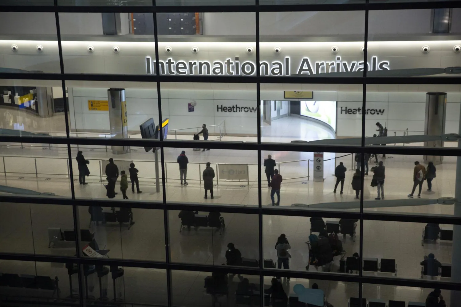 FILE In this file photo dated Tuesday, Jan. 26, 2021, people in the arrivals area at Heathrow Airport in London, during England's coronavirus lockdown. (AP Photo/Matt Dunham, FILE)
