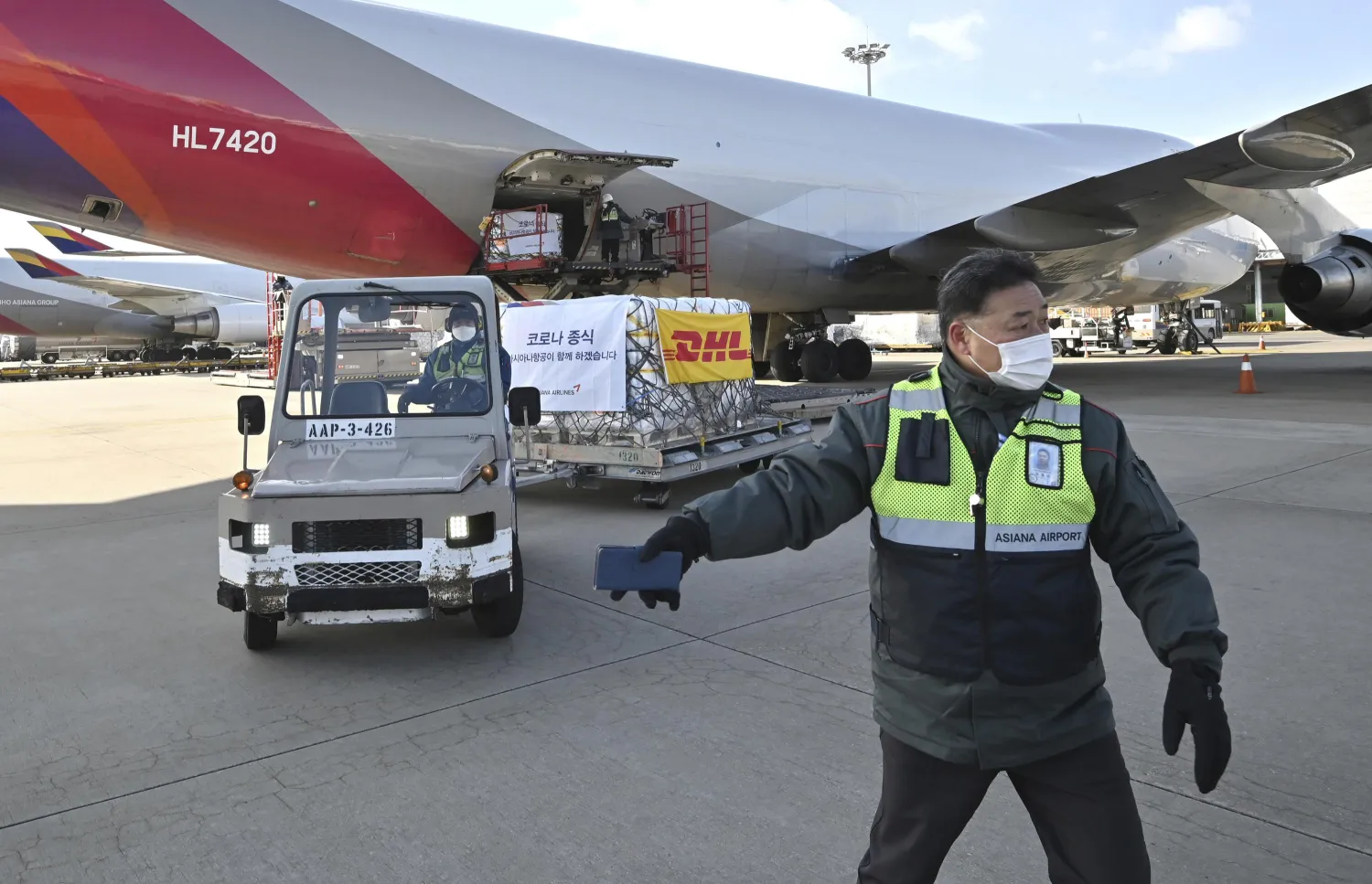 Workers transport a cargo shipment containing the first batches of Pfizer's antiviral COVID-19 pill, Paxlovid, at a cargo terminal at the Incheon International Airport, west of Seoul, South Korea, on Thursday, Jan. 13, 2022. Jung Yeon-je/Pool photo via AP)

