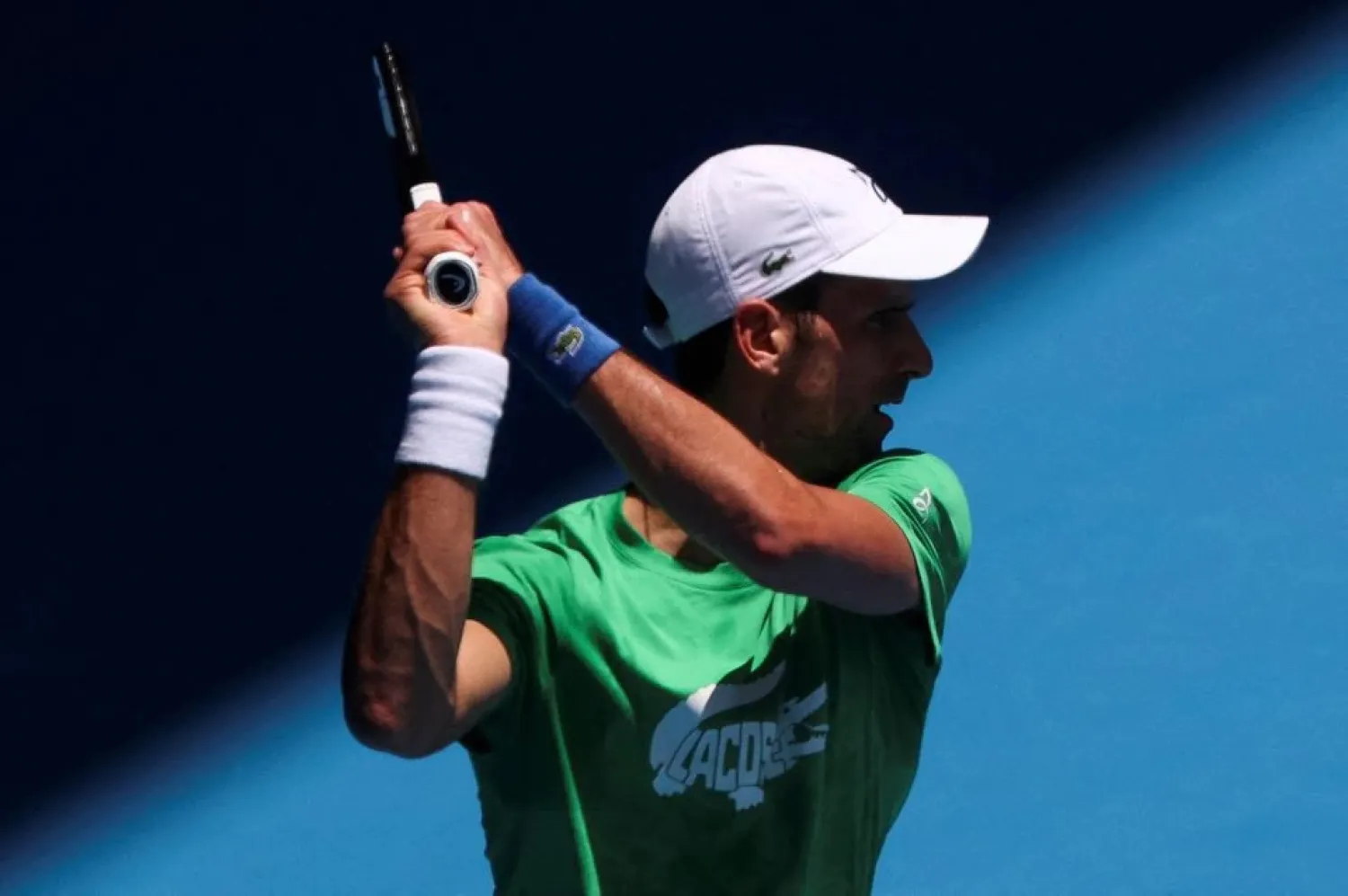 Serbian tennis player Novak Djokovic practices at Melbourne Park as questions remain over the legal battle regarding his visa to play in the Australian Open in Melbourne, Australia, January 13, 2022. (Reuters)