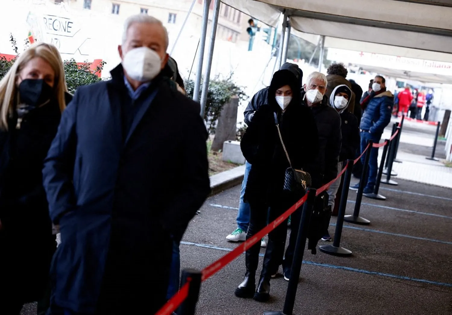 People wait to get a dose of the vaccine against the coronavirus disease (COVID-19), on the day Italy brings in tougher rules for the unvaccinated, at a Red Cross vaccination center by Termini main train station in Rome, Italy, January 10, 2022. (Reuters)