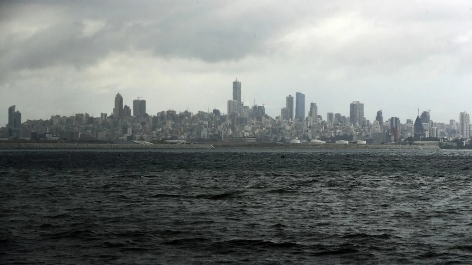 A picture taken from the seaside promenade of the northern Lebanese coastal town of Dbayeh shows the skyline of the Lebanese capital Beirut on March 17, 2020. (AFP)