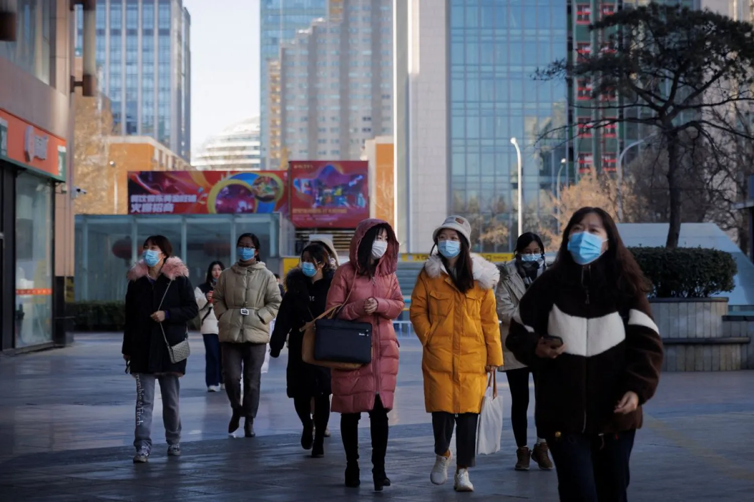 People walk on a street as the coronavirus disease (COVID-19) outbreak continues in Beijing, China, January 13, 2022. (Reuters)