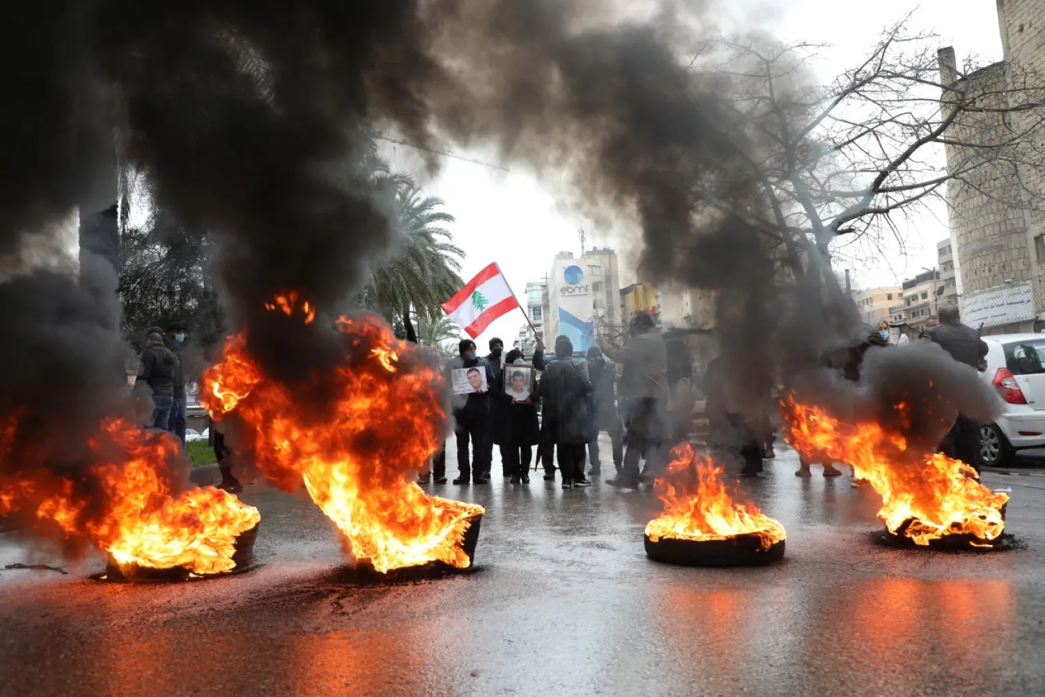 Relatives of victims of Beirut port explosion stand near burning tires during a protest outside the Justice Palace in Beirut, Lebanon February 19, 2021. REUTERS/Mohamed Azakir
 
