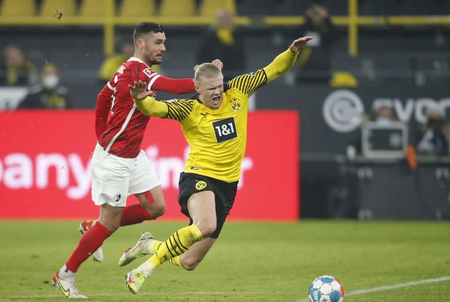Borussia Dortmund's Erling Braut Haaland in action with SC Freiburg's Manuel Gulde during the match on Friday. (Reuters)