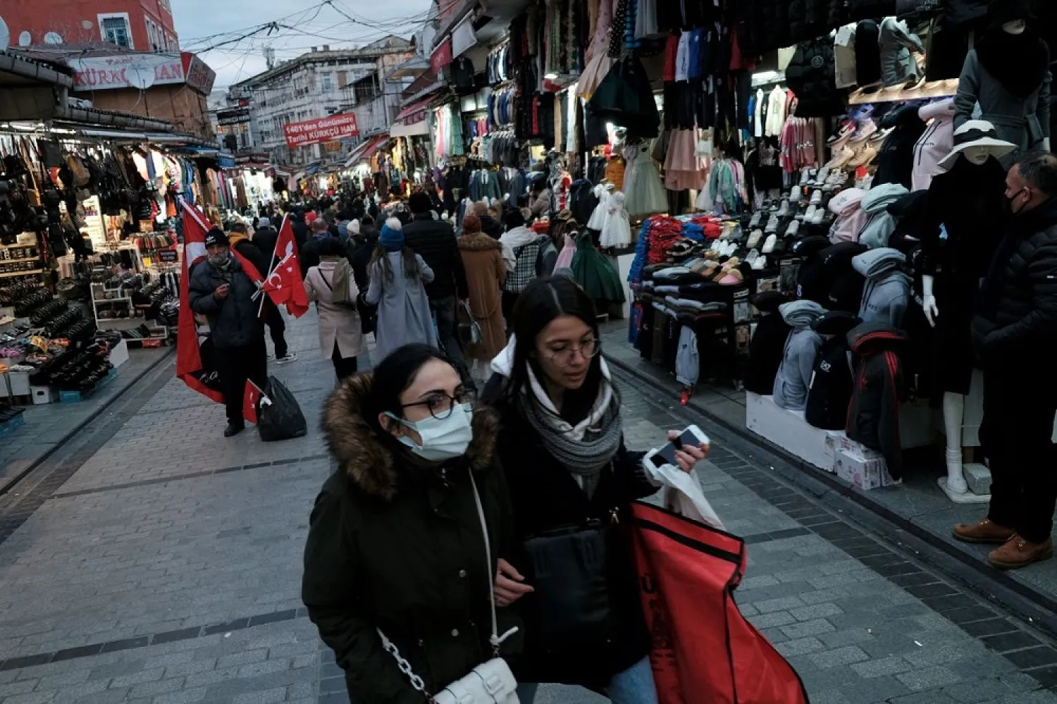 People stroll at Mahmutpasa street, a middle-class shopping area, as the coronavirus disease (COVID-19) outbreak continues in Istanbul, Turkey, January 13, 2022. (Reuters)