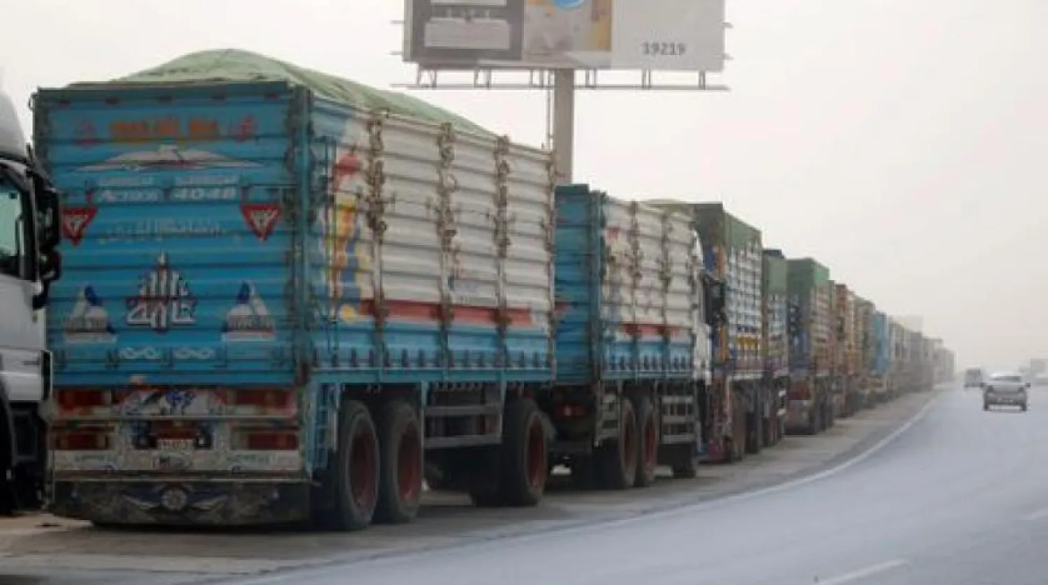 Trucks wait to pass through the main gate of the El Ain El Sokhna port to Suez Canal on dusty weather, Egypt March 24, 2021. REUTERS/Amr Abdallah Dalsh
