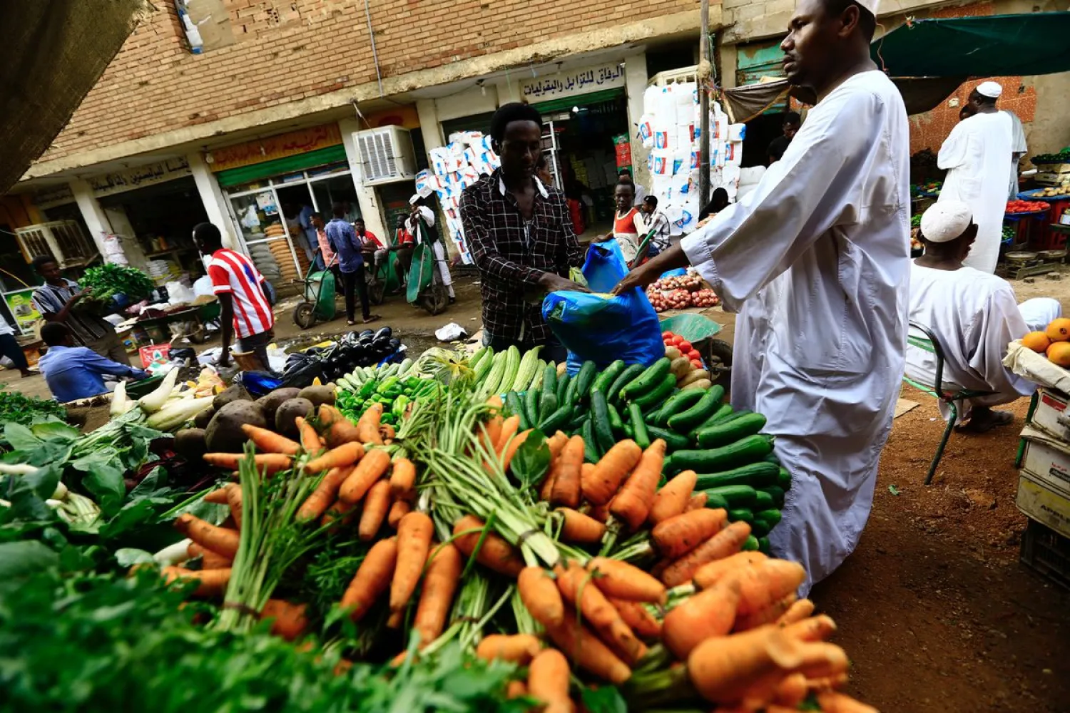 A man waits to buy food at a market in Khartoum. REUTERS/Mohamed Nureldin Abdallah