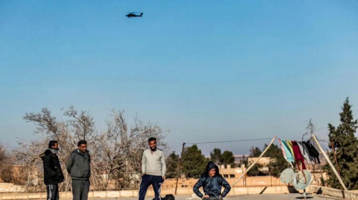 Citizens in an SDF-controlled area during the US forces’ patrol in a buffer zone with Turkish troops in northeastern Syria last month (AFP)