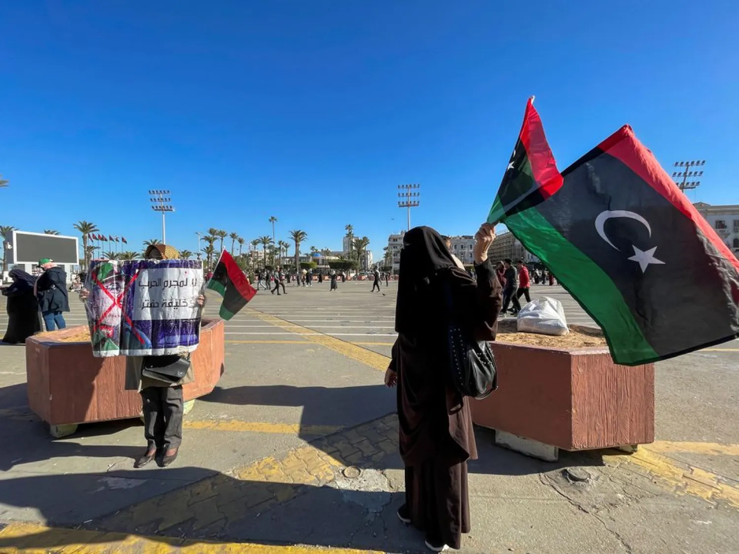 Protesters hold political banners and Libyan flags at Martyrs' Square in Tripoli, Libya, February 5, 2021. REUTERS/Hazem Ahmed





