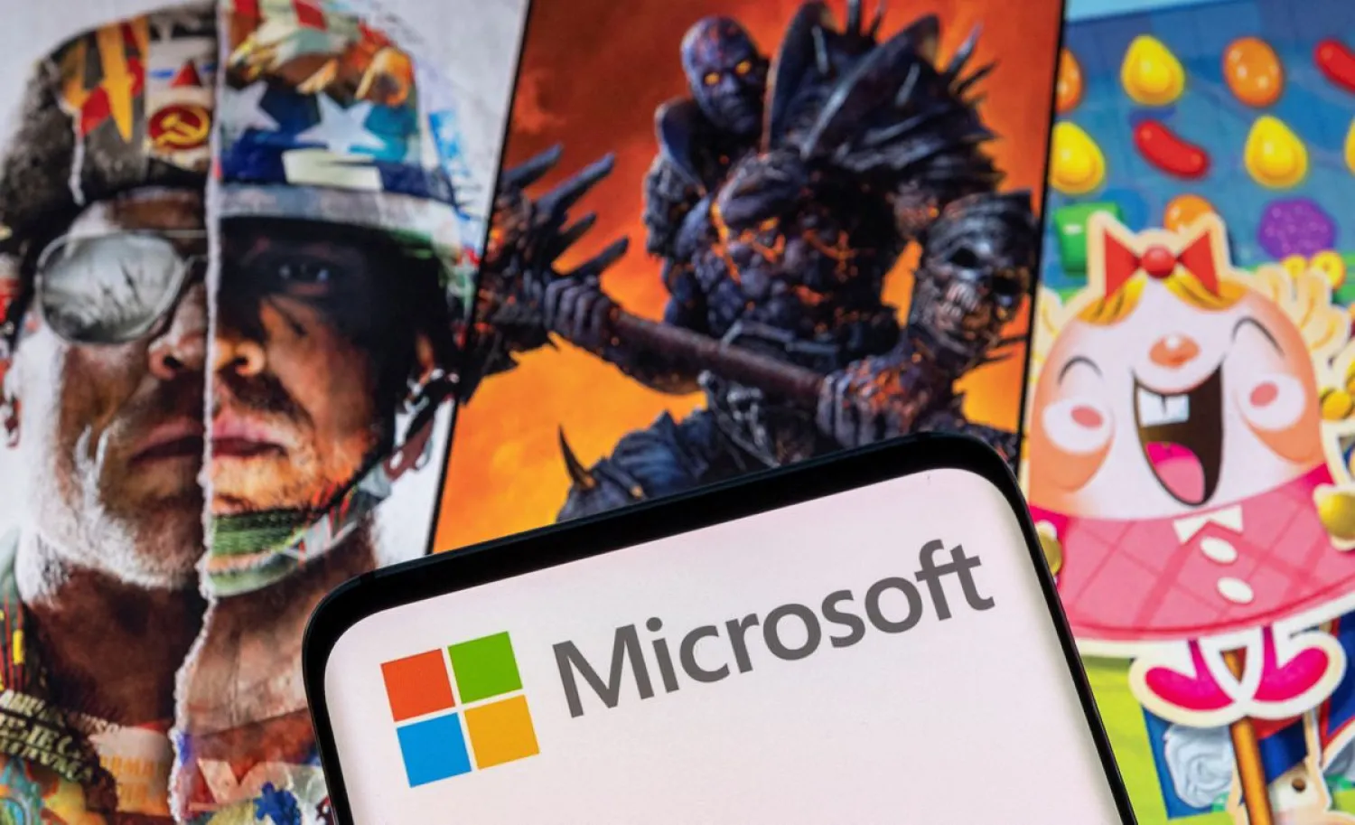 The Microsoft logo is seen in front of characters from Activision Blizzard games. (Reuters)