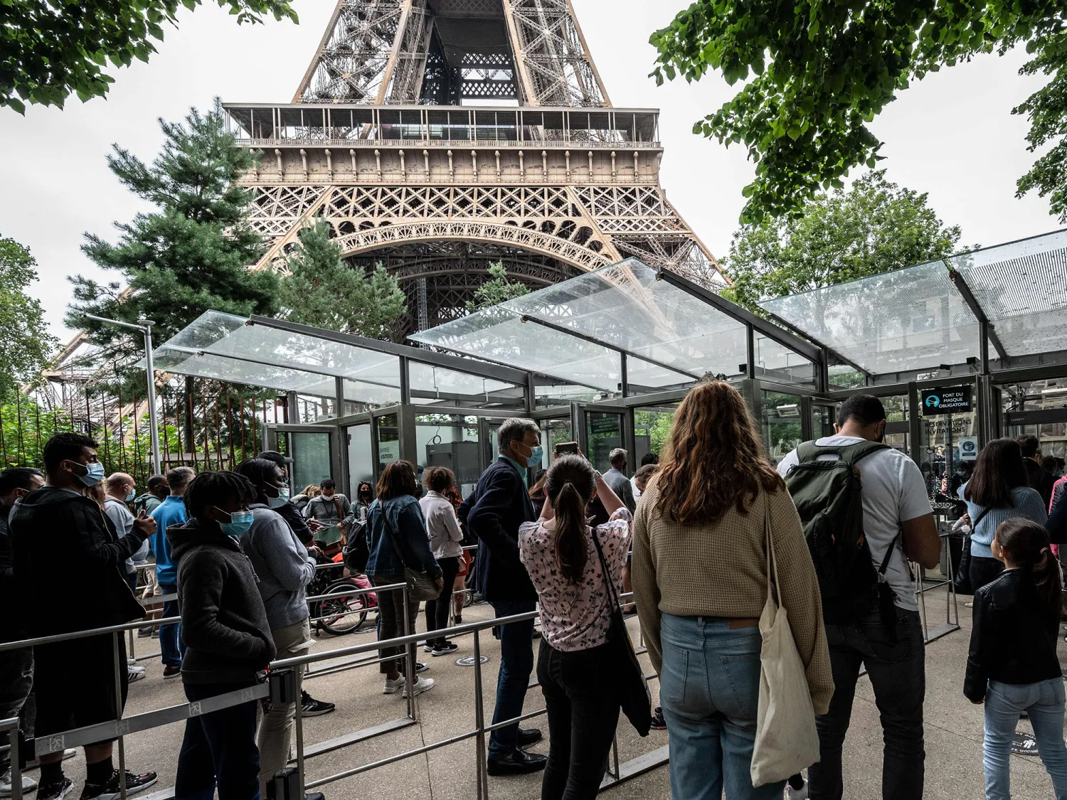 Visitors wait in line at the Eiffel Tower in Paris. Bertrand Guay/AFP/Getty Images