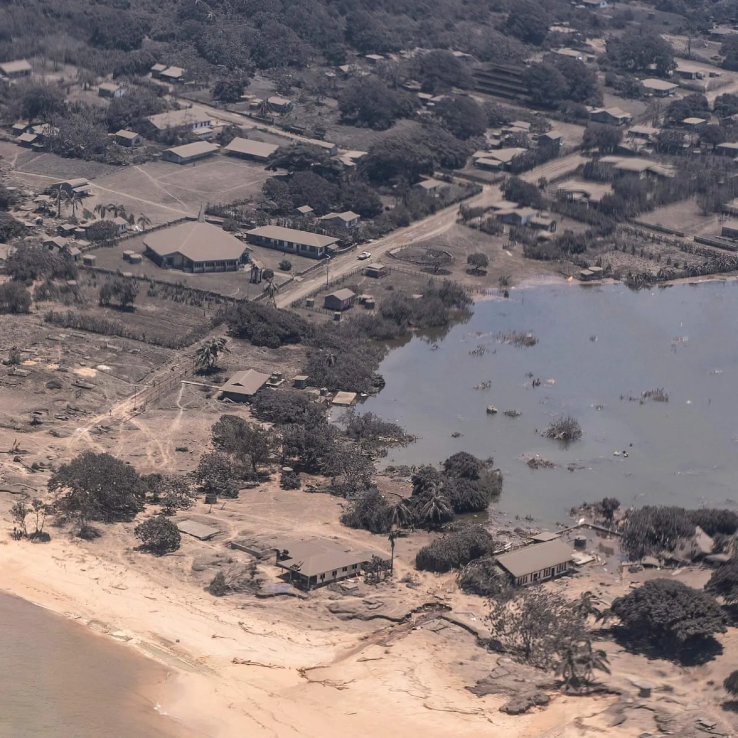 A New Zealand air force image shows homes in Tonga covered in volcanic ash after the huge eruption on Saturday. Photograph: New Zealand Defence Force/AFP/Getty Images