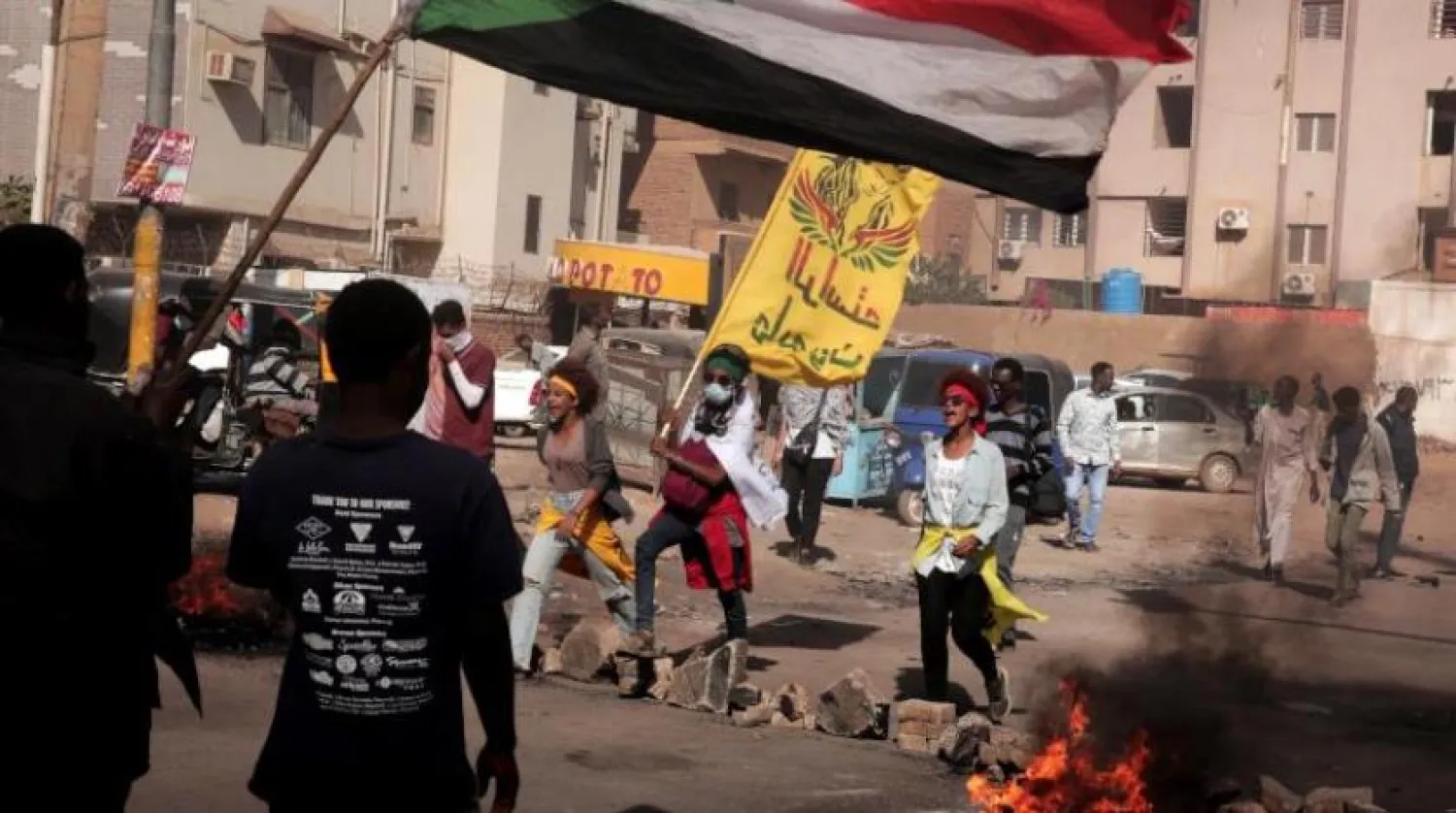 People burn tires and chant slogans during a demonstration against the killing of dozens by Sudanese security forces since the Oct. 25, 2021 military takeover, in Khartoum, Sudan, Thursday, Jan. 20, 2022. (AP Photo/Marwan Ali)
