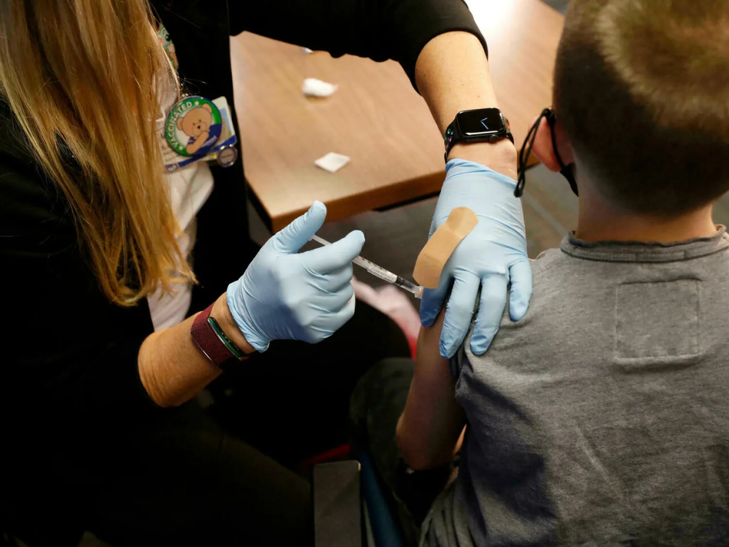 An eight-year-old child receives the Pfizer-BioNTech Covid-19 vaccine at the Beaumont Health offices in Southfield, Michigan on November 5, 2021. JEFF KOWALSKY AFP/File
