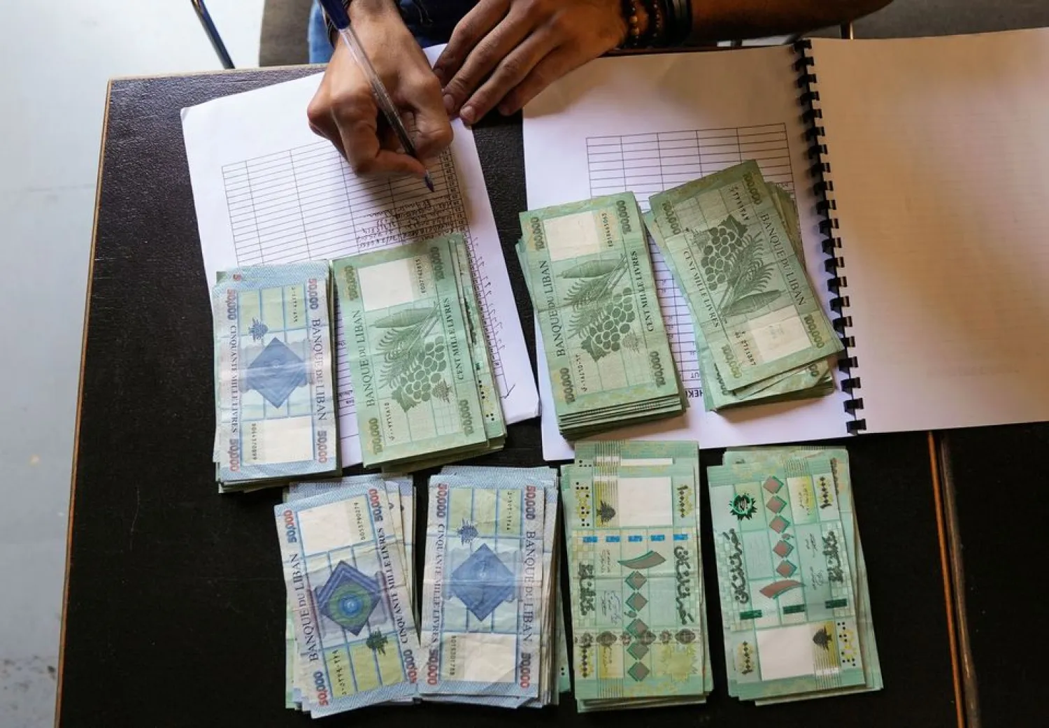 Lebanese pound banknotes are pictured on a desk in Beirut, Lebanon October 26, 2021. REUTERS/Issam Abdallah
