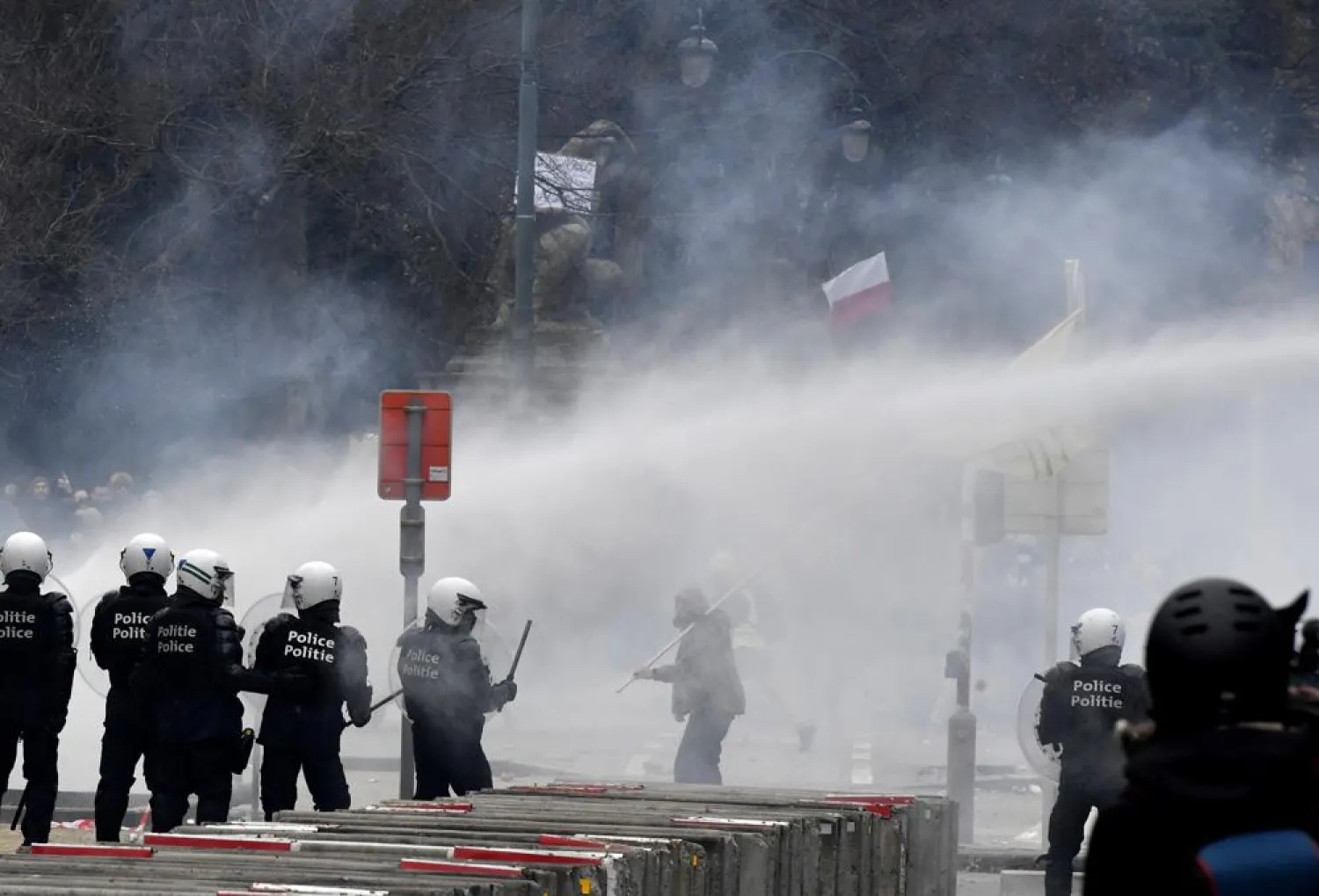 Police set off a water cannon against protestors during a demonstration against COVID-19 measures in Brussels, Sunday, Jan. 23, 2022. (AP)