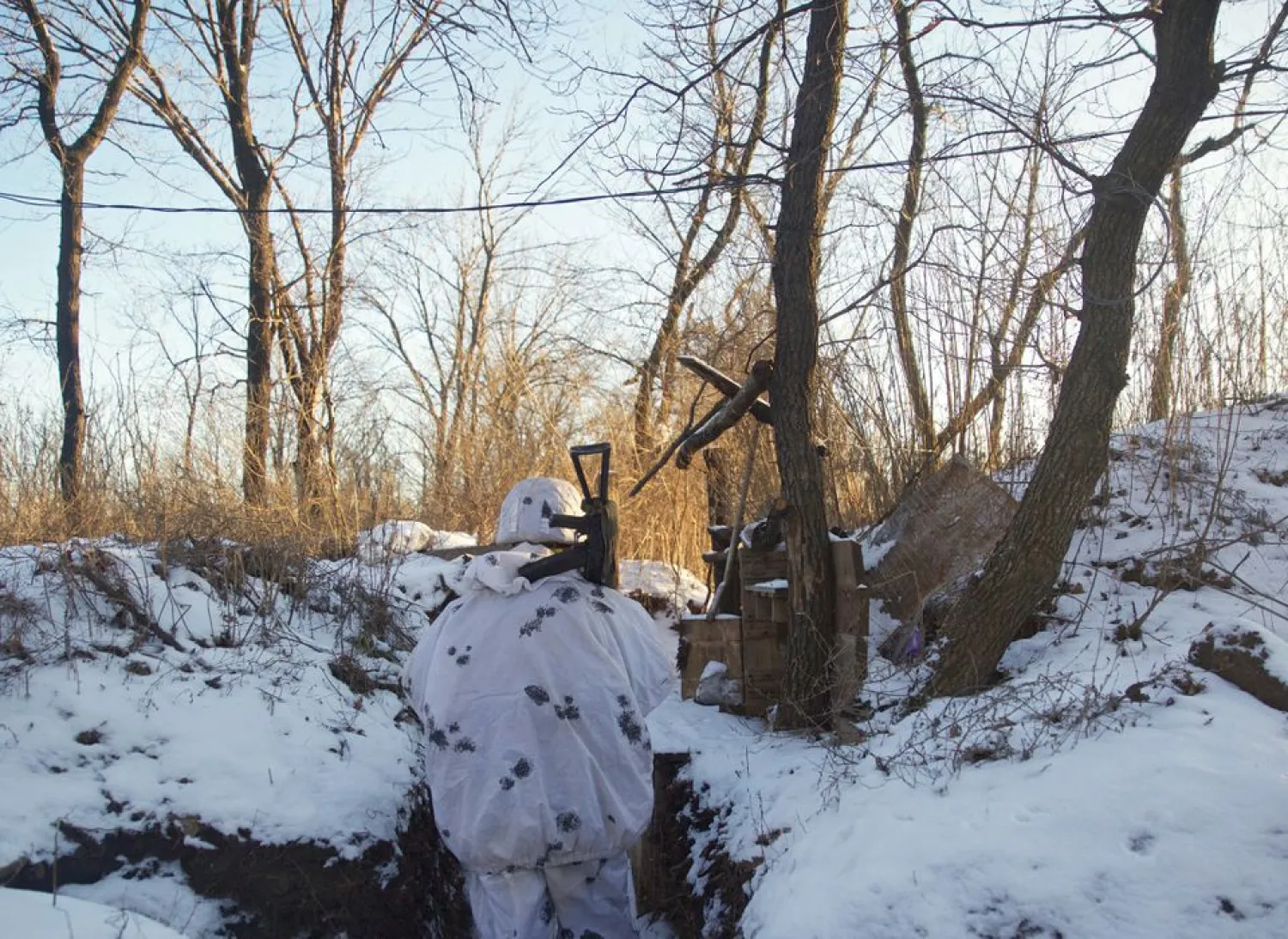 A service member of the Ukrainian armed forces stands guard at combat positions near the line of separation from Russian-backed rebels near Horlivka in the Donetsk region, Ukraine, January 20, 2022. (Reuters)